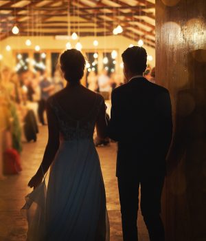 Rearview shot of a young couple arriving hand in hand at their wedding reception